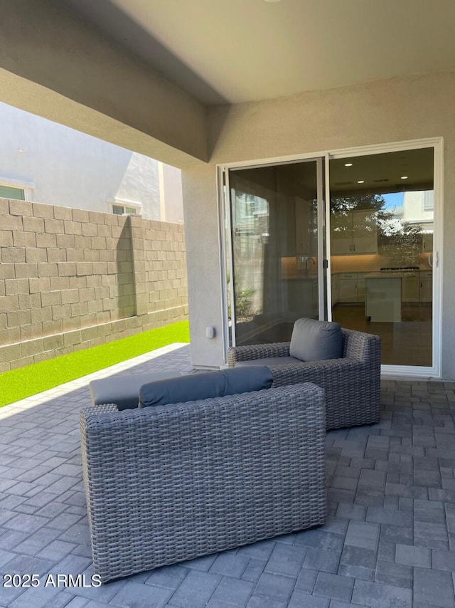 view of patio with an outdoor hangout area and fence