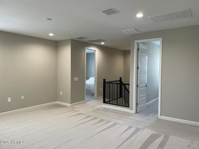 spare room with visible vents, recessed lighting, and baseboards