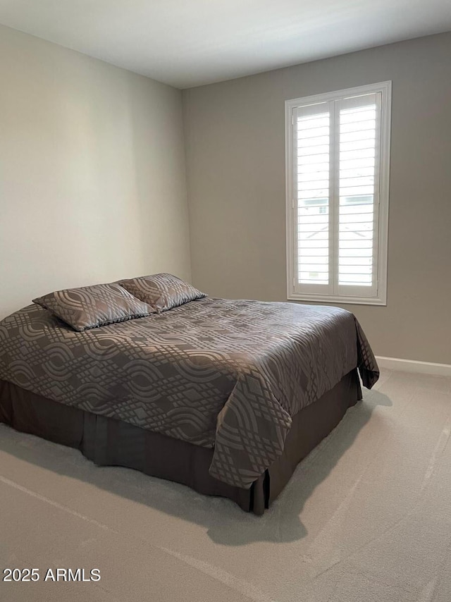 carpeted bedroom featuring baseboards