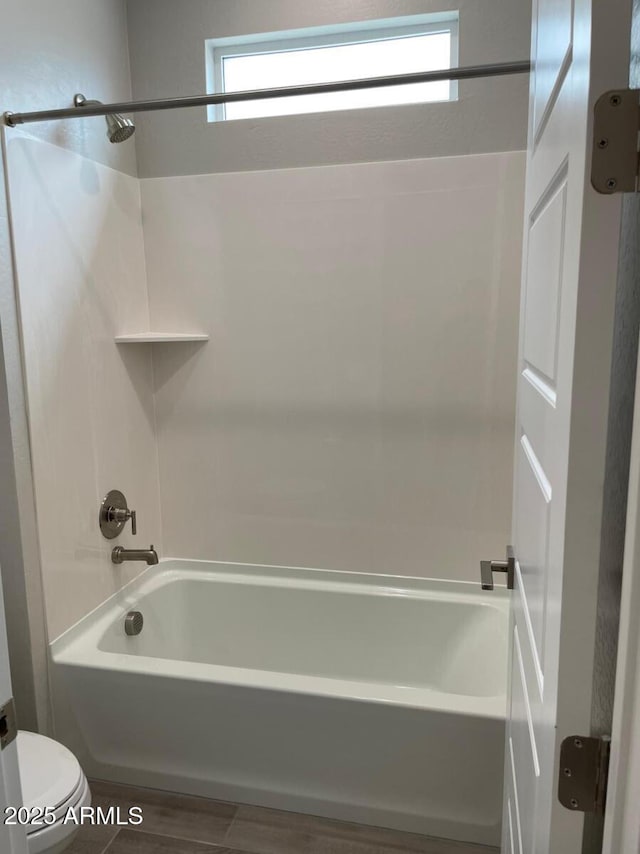 bathroom with toilet and shower / bathtub combination