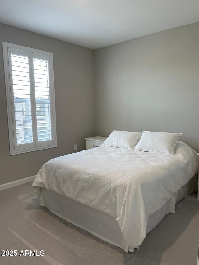 bedroom with carpet flooring and baseboards