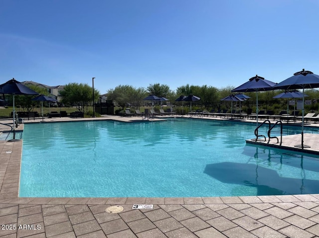 pool featuring fence and a patio area