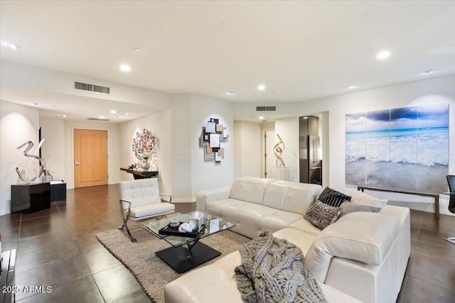 living area with recessed lighting, visible vents, and baseboards