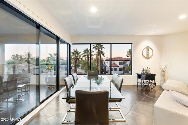 dining room with recessed lighting, a healthy amount of sunlight, and baseboards