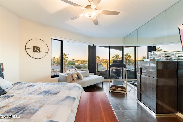 bedroom featuring dark tile patterned floors, multiple windows, and ceiling fan