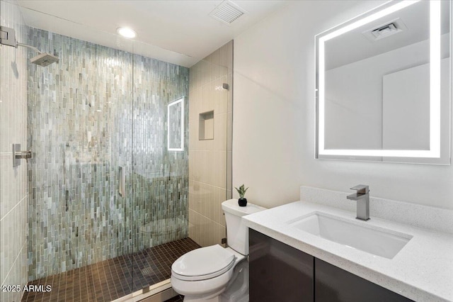 full bath with visible vents, a shower stall, toilet, and vanity