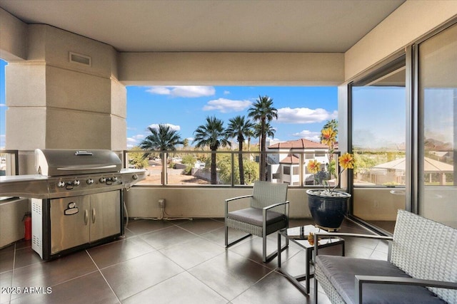 view of patio with a balcony, visible vents, and a grill