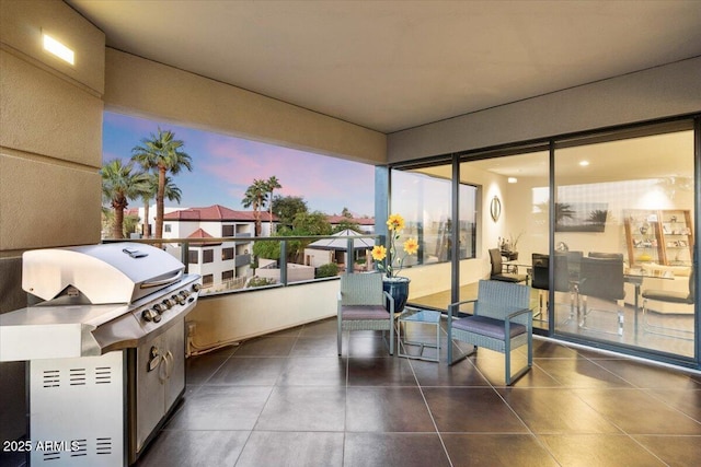 patio terrace at dusk featuring a balcony