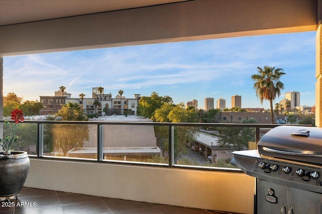 balcony with a city view and area for grilling