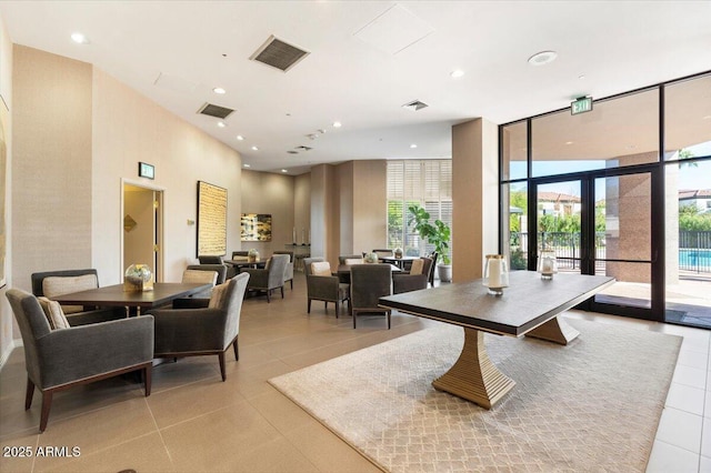 dining room featuring floor to ceiling windows, light tile patterned floors, and visible vents