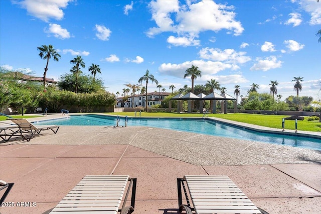 pool with a gazebo, a lawn, and a patio