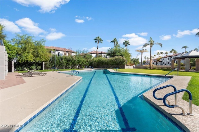 pool with a yard, a residential view, and a patio