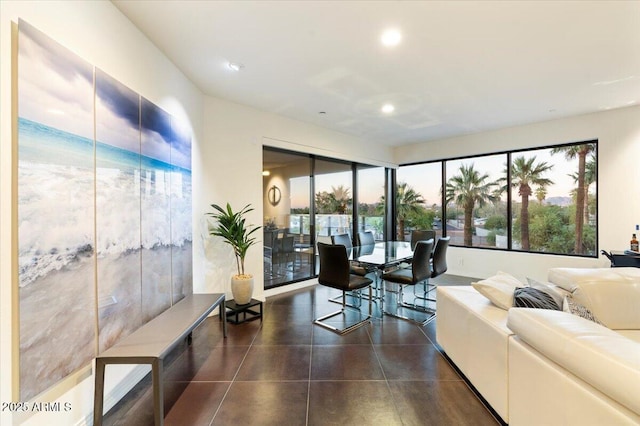 living area with dark tile patterned floors and recessed lighting