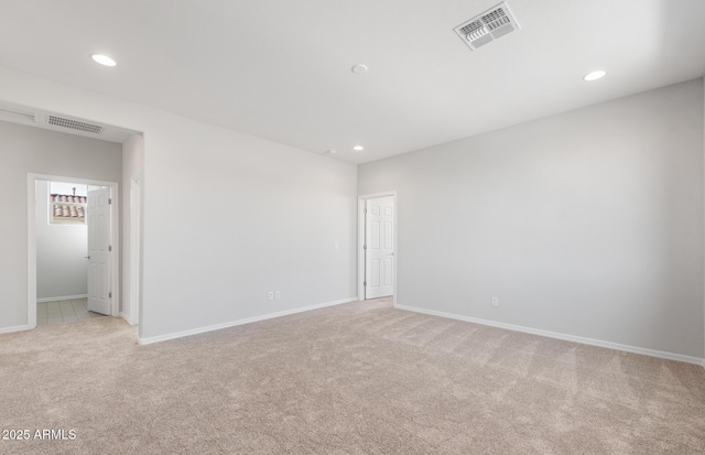 unfurnished room with light carpet