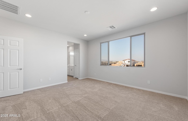 empty room featuring light carpet