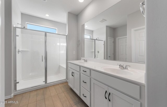 bathroom with vanity and an enclosed shower