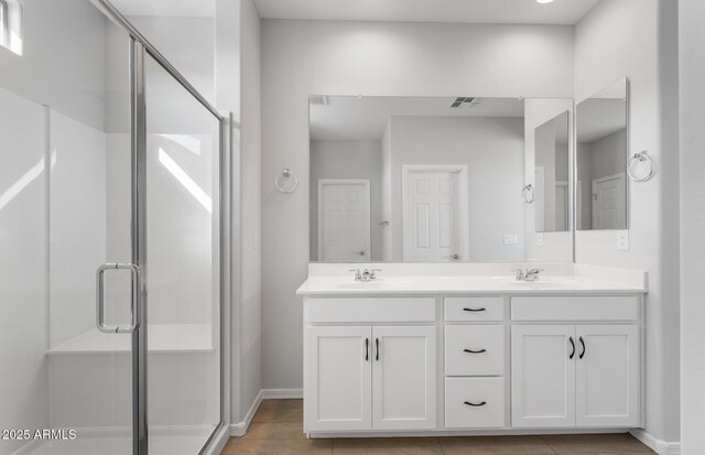 bathroom featuring walk in shower and vanity