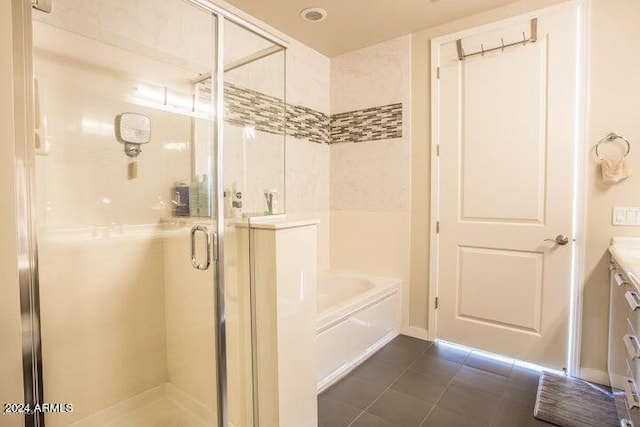 bathroom with tile patterned flooring, vanity, and separate shower and tub