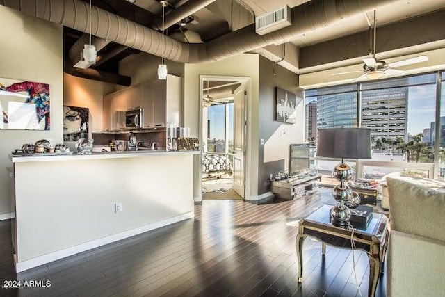 living room featuring wood-type flooring and ceiling fan