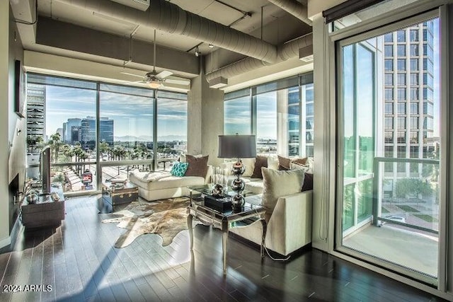 interior space with dark hardwood / wood-style flooring, ceiling fan, and a healthy amount of sunlight