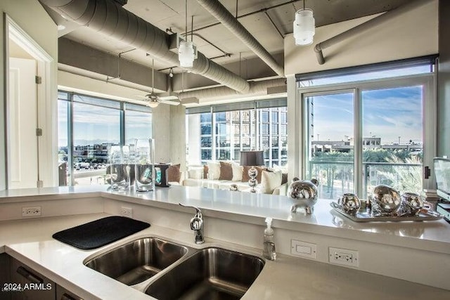 kitchen with sink, hanging light fixtures, and a healthy amount of sunlight