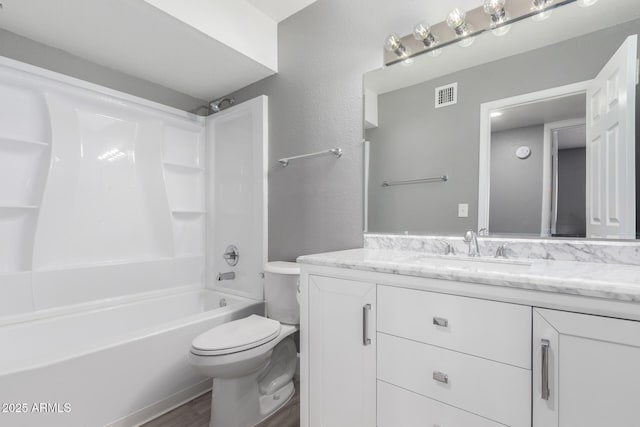 full bathroom with toilet,  shower combination, hardwood / wood-style floors, and vanity