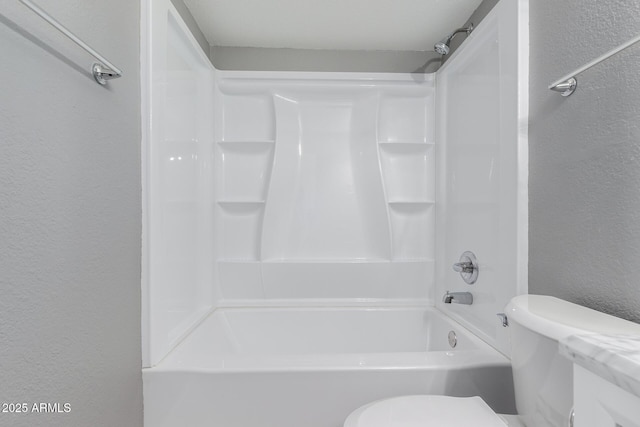 bathroom with toilet and shower / washtub combination