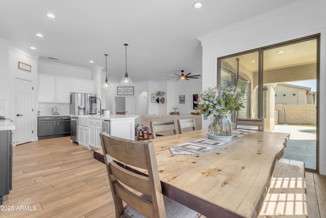 dining area with crown molding, light wood-style floors, ceiling fan, and recessed lighting