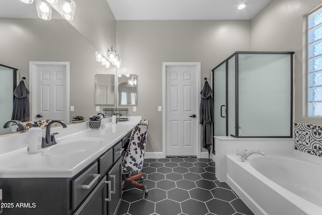 bathroom with a sink, a shower stall, plenty of natural light, and a garden tub