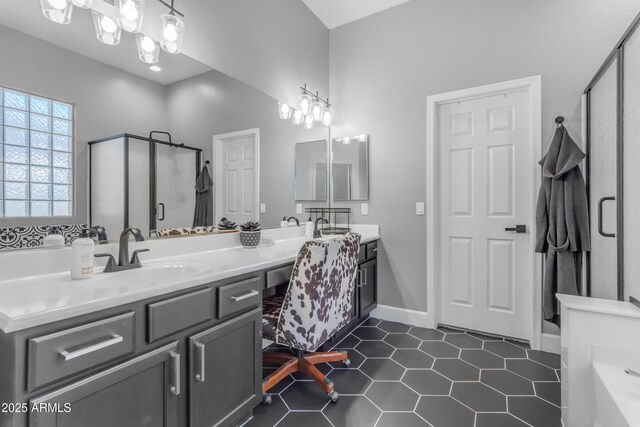 full bathroom with a shower stall, tile patterned floors, double vanity, and a sink