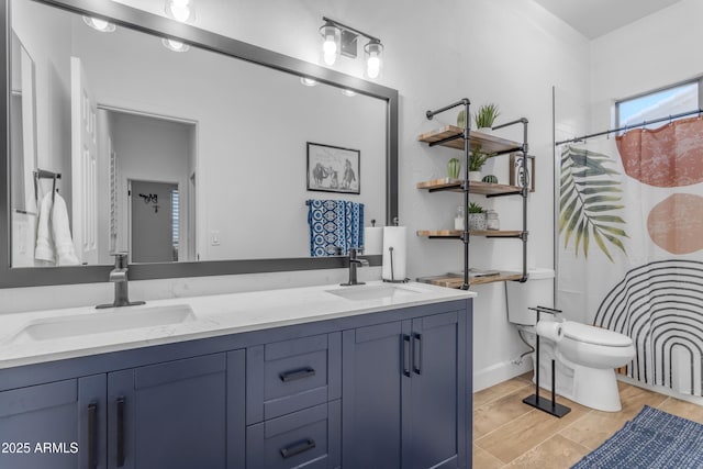 bathroom with toilet, double vanity, a sink, and a shower with curtain
