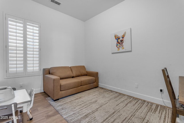 sitting room featuring wood finished floors, baseboards, and visible vents