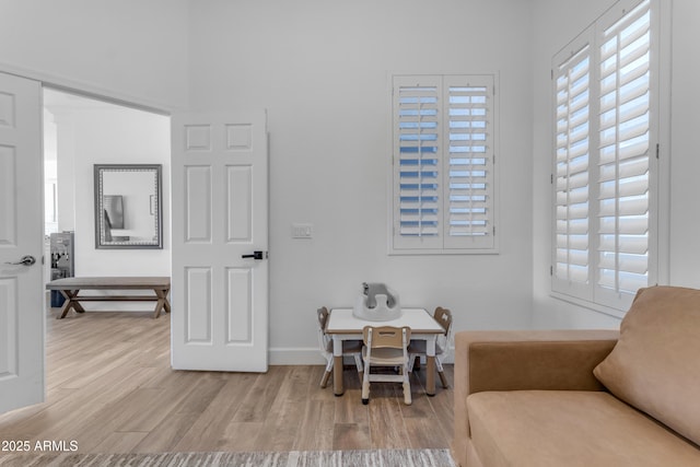 living area featuring baseboards and wood finished floors