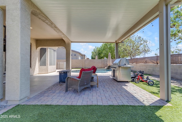 view of patio featuring a fenced in pool, a fenced backyard, and area for grilling