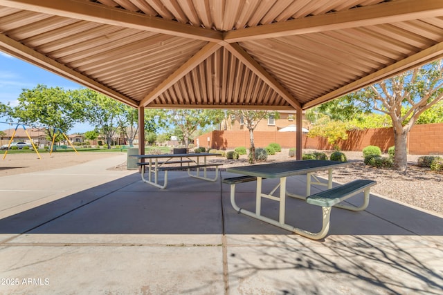 view of patio with outdoor dining area and fence