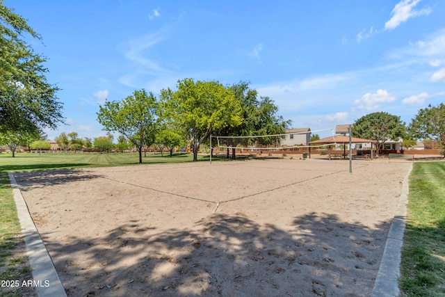 view of home's community featuring volleyball court and a lawn
