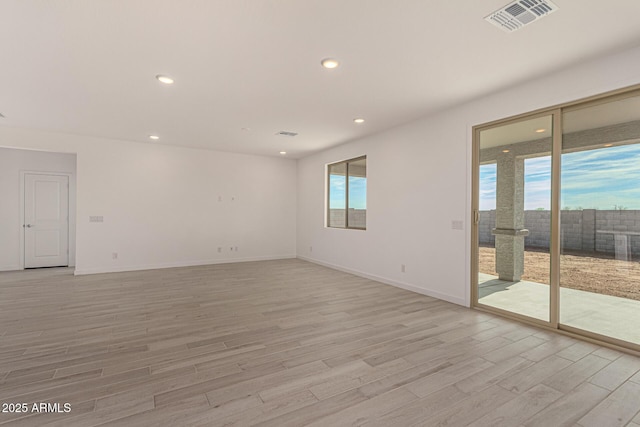 spare room featuring light hardwood / wood-style flooring