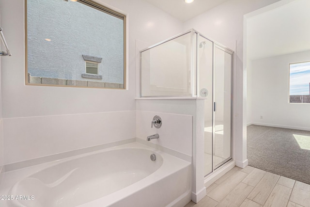 bathroom with plus walk in shower and hardwood / wood-style floors