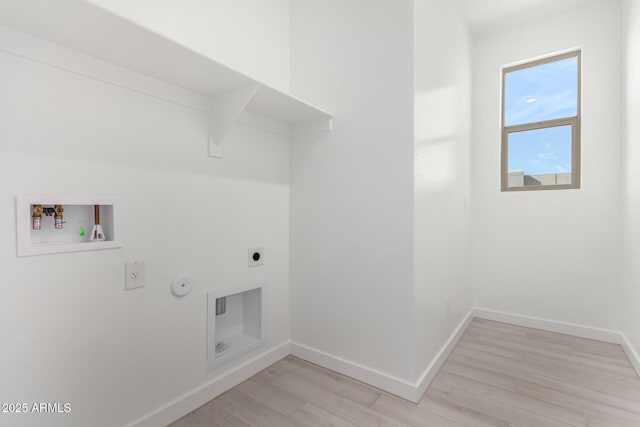 clothes washing area with gas dryer hookup, washer hookup, hookup for an electric dryer, and light hardwood / wood-style floors