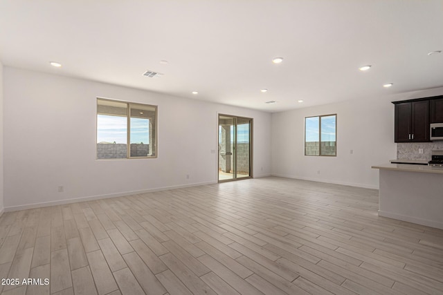 unfurnished living room with light wood-type flooring