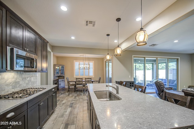 kitchen featuring a sink, a healthy amount of sunlight, stainless steel appliances, and visible vents