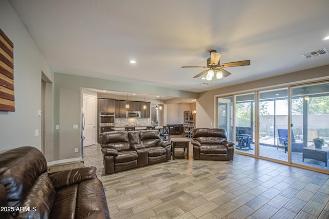 living room featuring visible vents, a ceiling fan, wood finish floors, and recessed lighting