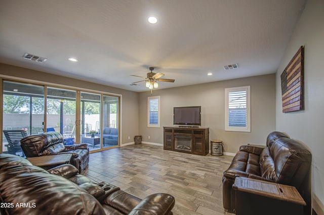 living room featuring a healthy amount of sunlight, recessed lighting, and visible vents