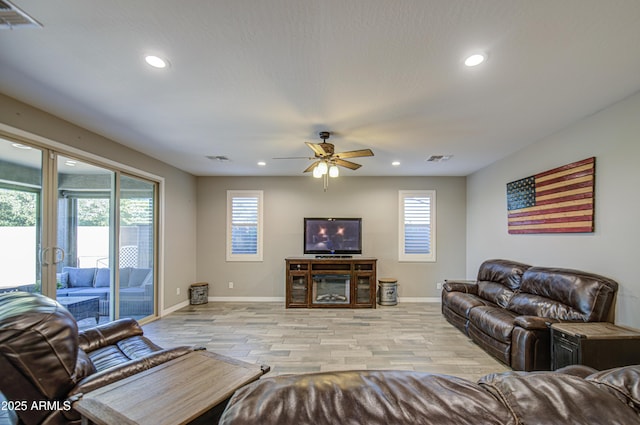 living area featuring recessed lighting, light wood-style flooring, and a wealth of natural light