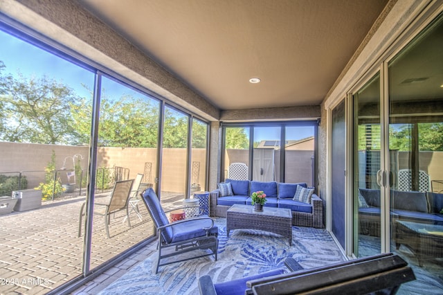 sunroom / solarium with a healthy amount of sunlight and outdoor lounge area