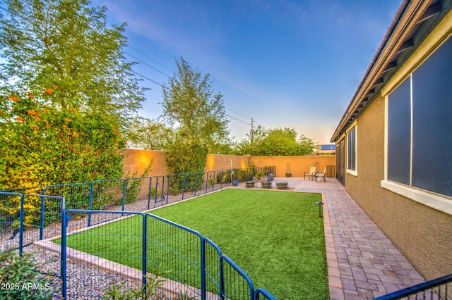 view of yard with a fenced backyard and a patio area