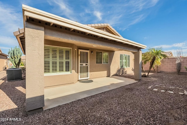 back of house featuring a patio area and central air condition unit