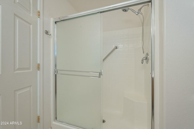 bathroom with a shower with shower door