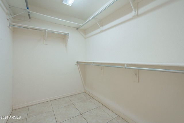 spacious closet featuring light tile patterned floors