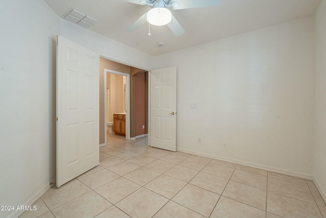 tiled empty room with ceiling fan